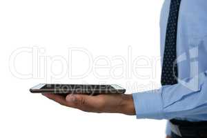 Mid section of businessman holding tablet