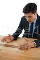 Businessman gesturing at table during meeting