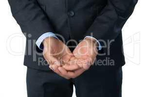 Midsection of businessman with hands cupped