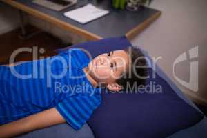 High angle view of boy lying on blue bed