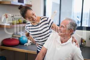 Smiling female doctor looking at senior patient