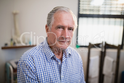 Portrait of senior male patient against window