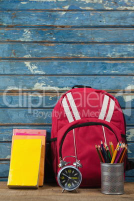 Bagpack, books, alarm clock and pen holder