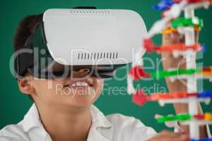 Schoolboy using virtual reality headset in laboratory