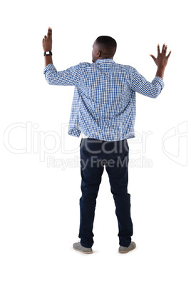 Man pretending to touch an invisible screen against white background