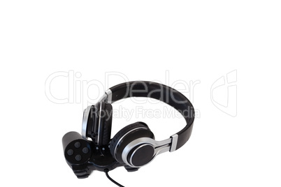 Joystick and headphones on white background