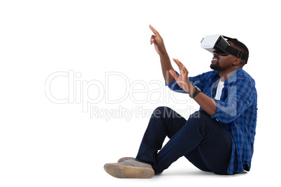 Man gesturing while using virtual reality headset and digital tablet