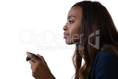 Side view of businesswoman playing video game