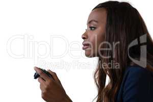 Side view of businesswoman playing video game