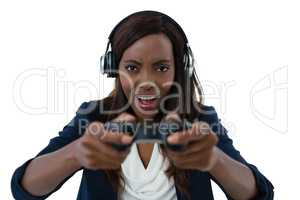 Young businesswoman wearing headphones while playing video game