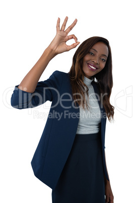 Portrait of smiling businesswoman showing ok sign