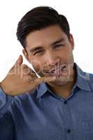 Portrait of businessman gesturing call hand sign