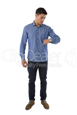 Full length of businessman looking at time