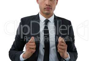Mid section of businessman holding transparent interface
