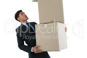 Businessman balancing cardboard boxes