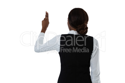 Rear view of businesswoman using invisible interface