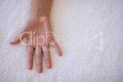 Overhead view of palm on white towel