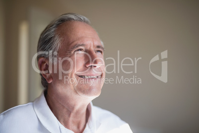 Close-up of smiling senior male patient looking away