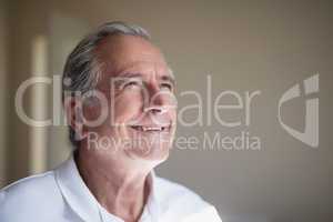 Close-up of smiling senior male patient looking away