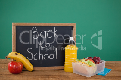 Slate with text back to school and breakfast on table