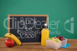 Slate with text back to school and breakfast on table