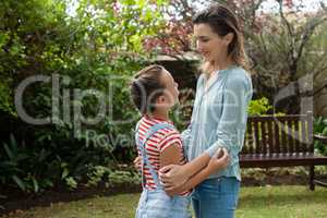 Side view of woman and daughter looking at each other