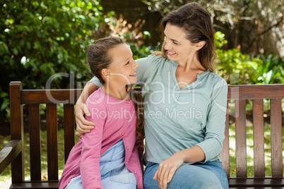 Smiling woman and daughter looking at each other