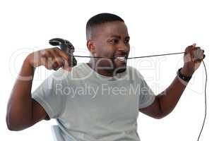 Frustrated man biting a wire of joystick