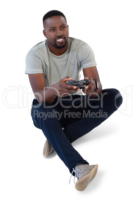 Man playing video game against white background Man playing video game against white background