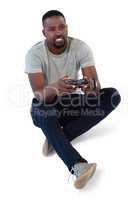 Man playing video game against white background