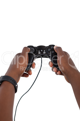 Hand of man playing video game against white background