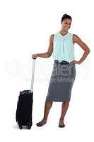 Smiling businesswoman posing with a suitcase