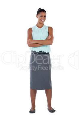 Businesswoman standing with arms crossed against white background
