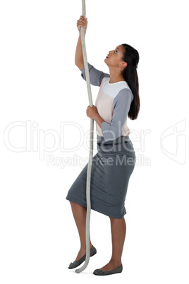 Businesswoman climbing the rope