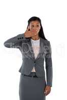 Surprised businesswoman covering her mouth with hand