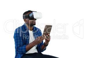 Man using virtual reality headset and digital tablet