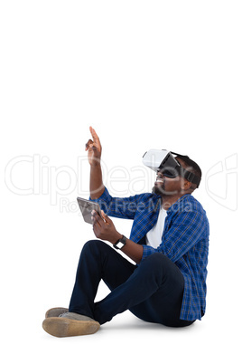 Man gesturing while using virtual reality headset and digital tablet