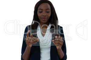 Smiling businesswoman holding transparent interface screen