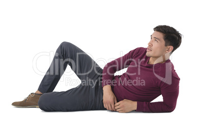 Full length of businessman reclining while looking away