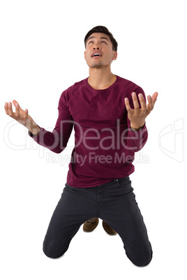 Businessman gesturing while kneeling