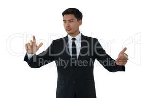 Young businessman touching invisible interface screen