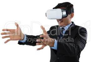Smiling young businessman gesturing while using vr glasses