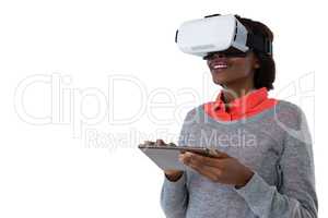Young woman wearing vr glasses while using tablet computer