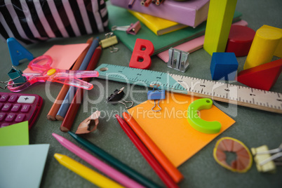 Various school supplies on chalkboard