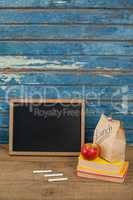 Slate, chalk, apple, lunch bag and books