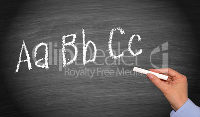 Writing ABC on chalkboard or blackboard