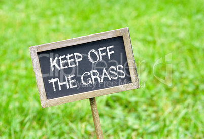 Keep off the grass - chalkboard on grass background