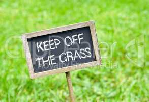 Keep off the grass - chalkboard on grass background