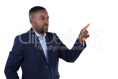 Businessman pressing an invisible virtual screen