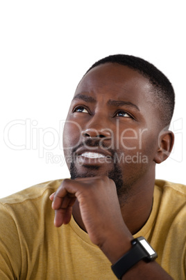 Man with hand on chin against white background